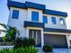 Contemporary two-story home with modern design, landscaping, and a two-car garage at 818 W Adalee St, Tampa, FL 33603