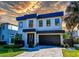Contemporary two-story home with modern design, landscaped yard, and a two car garage at 818 W Adalee St, Tampa, FL 33603