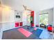 Spacious gym with built-in storage, mounted TV, weights, and yoga mat at 818 W Adalee St, Tampa, FL 33603