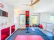 Well-equipped home gym featuring modern fitness equipment, storage, and natural light at 818 W Adalee St, Tampa, FL 33603