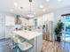 Modern kitchen with white cabinets, stainless steel appliances, a large island, and stylish pendant lighting at 818 W Adalee St, Tampa, FL 33603