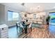 Bright open-concept kitchen with modern white cabinetry, stainless steel appliances, and a dining area at 818 W Adalee St, Tampa, FL 33603