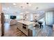 Open-concept kitchen and dining area with modern island, stainless appliances, and stylish decor at 818 W Adalee St, Tampa, FL 33603