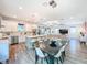 Open-concept kitchen with white cabinets, stainless steel appliances, an island, and an adjacent living area at 818 W Adalee St, Tampa, FL 33603