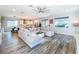 Spacious living room with a large sectional sofa, wood-look flooring, and an open view into the kitchen at 818 W Adalee St, Tampa, FL 33603