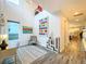 Bright, airy living room with neutral decor, modern artwork, and wood-look flooring flowing into the kitchen area at 818 W Adalee St, Tampa, FL 33603