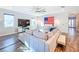 Comfortable living room with a large TV, sectional sofa, and neutral tones complemented by stylish decor at 818 W Adalee St, Tampa, FL 33603
