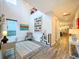 Bright, airy living room with neutral decor, modern artwork, and wood-look flooring flowing into the kitchen area at 818 W Adalee St, Tampa, FL 33603