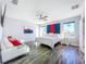Bright main bedroom with modern decor, hardwood floors, and ample natural light at 818 W Adalee St, Tampa, FL 33603