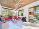 Screened patio with comfortable seating, a ceiling fan, and access to the indoors, perfect for entertaining guests at 818 W Adalee St, Tampa, FL 33603