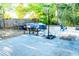 Inviting backyard area featuring a covered ping pong table, propane tanks, a grill, and a basketball hoop at 895 64Th S Ave, St Petersburg, FL 33705