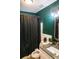 The bathroom features a white toilet and cabinets, granite countertops, chrome fixtures, and emerald green walls at 895 64Th S Ave, St Petersburg, FL 33705