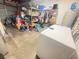 A cluttered garage contains an abundance of storage shelving and other items needing organization at 895 64Th S Ave, St Petersburg, FL 33705