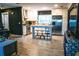 Open floor plan showcasing kitchen with stainless steel appliances, island with seating, and white cabinetry at 895 64Th S Ave, St Petersburg, FL 33705