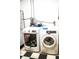 Well-lit laundry room equipped with a modern washing machine and dryer with tiled floor and ample space at 895 64Th S Ave, St Petersburg, FL 33705