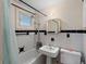 Classic bathroom with white tiled walls, vintage fixtures, and a shower-tub combination at 130 4Th N Ave # 414, St Petersburg, FL 33701