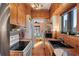 Functional kitchen with wood cabinets, a black sink, and a bright view to the dining area at 130 4Th N Ave # 414, St Petersburg, FL 33701