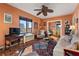 Cozy living room featuring a large window, ceiling fan, a stylish rug and comfortable seating arrangements at 130 4Th N Ave # 414, St Petersburg, FL 33701