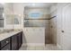 Bright bathroom showcasing a glass enclosed shower with neutral tile, granite counters, and vanity at 19724 Post Island Loop, Land O Lakes, FL 34638