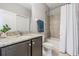 Well-lit bathroom features a granite countertop, vanity, and shower-tub combo at 19724 Post Island Loop, Land O Lakes, FL 34638