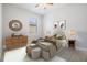 Bright bedroom featuring neutral tones, a comfortable bed, and stylish decor at 19724 Post Island Loop, Land O Lakes, FL 34638