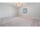 Comfortable bedroom with plush carpeting and a window offering natural light at 19724 Post Island Loop, Land O Lakes, FL 34638