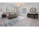 Well-lit bedroom with a plush bed, decorative rug, and elegant furnishings at 19724 Post Island Loop, Land O Lakes, FL 34638