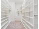 Spacious walk-in closet with custom shelving and ample storage space at 19724 Post Island Loop, Land O Lakes, FL 34638