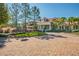 Beautiful community center featuring well-manicured landscaping and a circular brick driveway at 19724 Post Island Loop, Land O Lakes, FL 34638