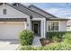 Charming home featuring an inviting front entrance with manicured landscaping and a well-maintained exterior at 19724 Post Island Loop, Land O Lakes, FL 34638