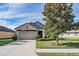 Charming home with a well-manicured lawn, mature tree, and inviting driveway at 19724 Post Island Loop, Land O Lakes, FL 34638