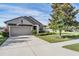 Attractive home featuring a manicured lawn, a mature tree, and an attached garage at 19724 Post Island Loop, Land O Lakes, FL 34638
