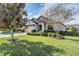 Beautiful home with lush landscaping, a well-maintained lawn, and a welcoming entrance at 19724 Post Island Loop, Land O Lakes, FL 34638