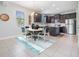 Eat-in kitchen with stainless appliances, dark cabinets, and a tile floor at 19724 Post Island Loop, Land O Lakes, FL 34638
