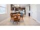 Open kitchen with dark cabinetry, stainless appliances, and a view to the dining area at 19724 Post Island Loop, Land O Lakes, FL 34638