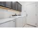 Laundry room with new appliances, overhead cabinets, and ample space at 19724 Post Island Loop, Land O Lakes, FL 34638