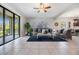 Bright and open living area with sliding glass doors, tile flooring, and tasteful furnishings at 19724 Post Island Loop, Land O Lakes, FL 34638