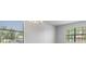 A living room features two large windows allowing in natural light, and a chandelier at 19724 Post Island Loop, Land O Lakes, FL 34638