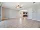 Bright, open-concept living room with tiled flooring and a view into the modern kitchen at 19724 Post Island Loop, Land O Lakes, FL 34638
