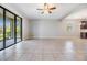 Spacious living room with large sliding glass doors, tile flooring, and neutral paint at 19724 Post Island Loop, Land O Lakes, FL 34638