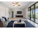 Bright and open living area with sliding glass doors, tile flooring, and modern furnishings at 19724 Post Island Loop, Land O Lakes, FL 34638
