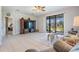 Open concept living room leading to lanai, neutral paint and tile floors at 19724 Post Island Loop, Land O Lakes, FL 34638