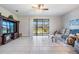 Bright living room with screened in lanai and ceiling fan at 19724 Post Island Loop, Land O Lakes, FL 34638