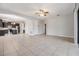 Open concept living space features tile flooring, dark wood kitchen, and neutral walls at 19724 Post Island Loop, Land O Lakes, FL 34638