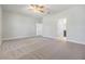 Spacious main bedroom featuring neutral carpeting and an ensuite bathroom at 19724 Post Island Loop, Land O Lakes, FL 34638