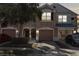 Charming multi-story townhome featuring an attached garage and well-maintained landscaping at 26614 Castleview Way, Wesley Chapel, FL 33544