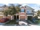 Charming two-story townhome with a one-car garage, landscaped front yard, and welcoming curb appeal at 26614 Castleview Way, Wesley Chapel, FL 33544