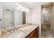 This bathroom features a large vanity, decorative lighting, and a walk in shower at 301 Cordova Grn, Seminole, FL 33777