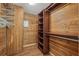 Spacious wood-lined walk-in closet with shelving and hanging rods for optimal storage in the home at 301 Cordova Grn, Seminole, FL 33777