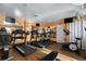 Fitness center with wood-look flooring, mirrors, multiple treadmills, an elliptical, and a stationary bike at 3010 59Th S St # 304, Gulfport, FL 33707